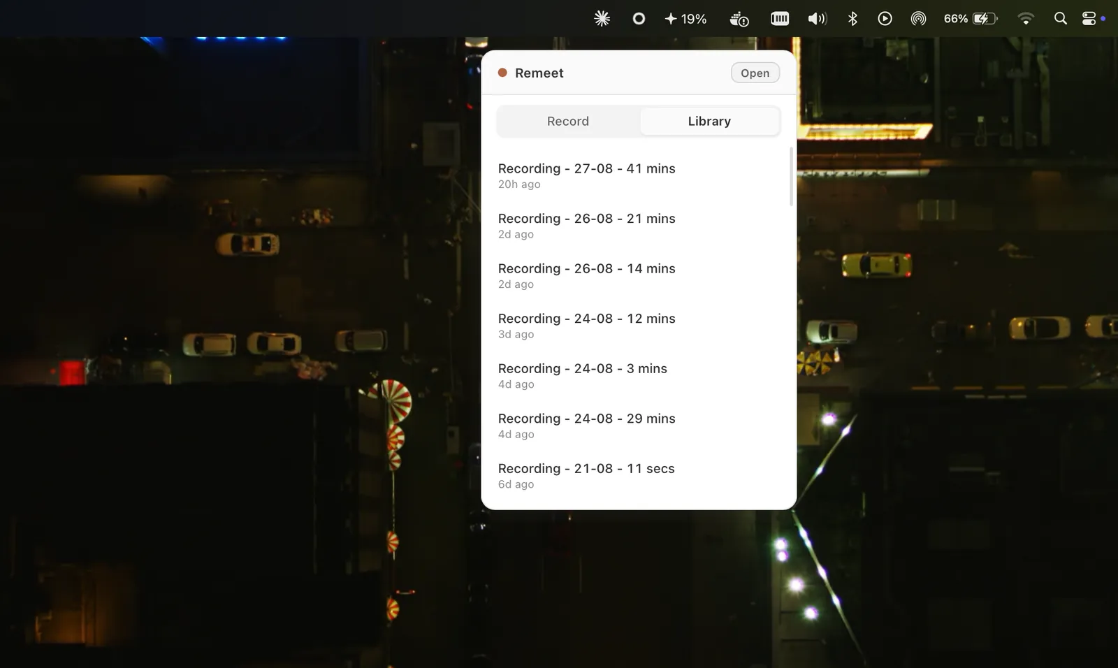 The Remeet menu bar popover open over a desktop, listing past recordings with their length