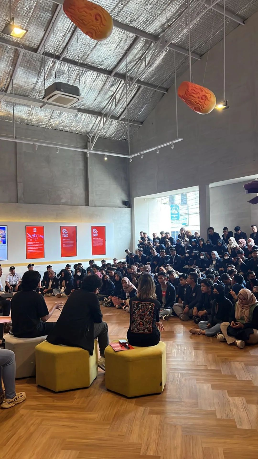 Native Productions team members speaking to a room full of students.
